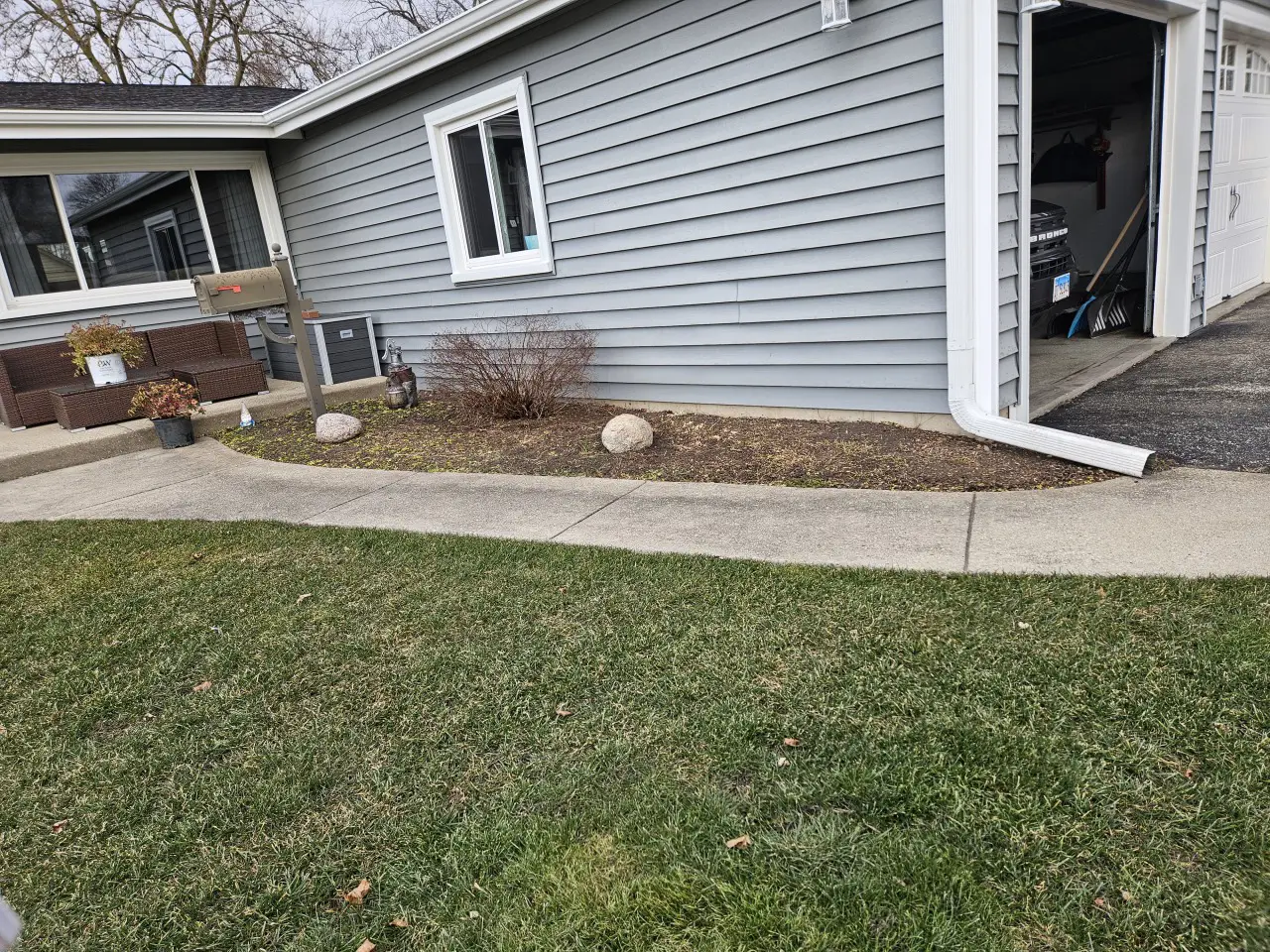 Residential lawn care and landscape maintenance featuring fresh green grass and clean foundation planting bed